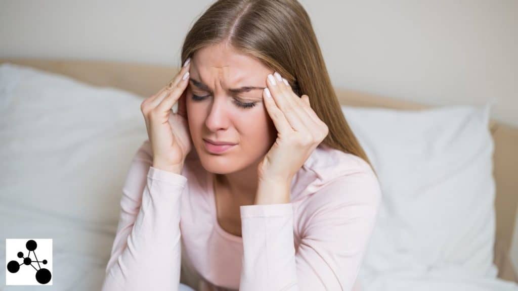 Image of a woman having headache after manifesting